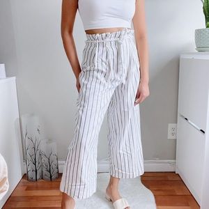 White wide leg pants with vertical line prints.